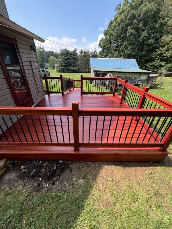 Red-painted deck with contrasting dark railing spindles