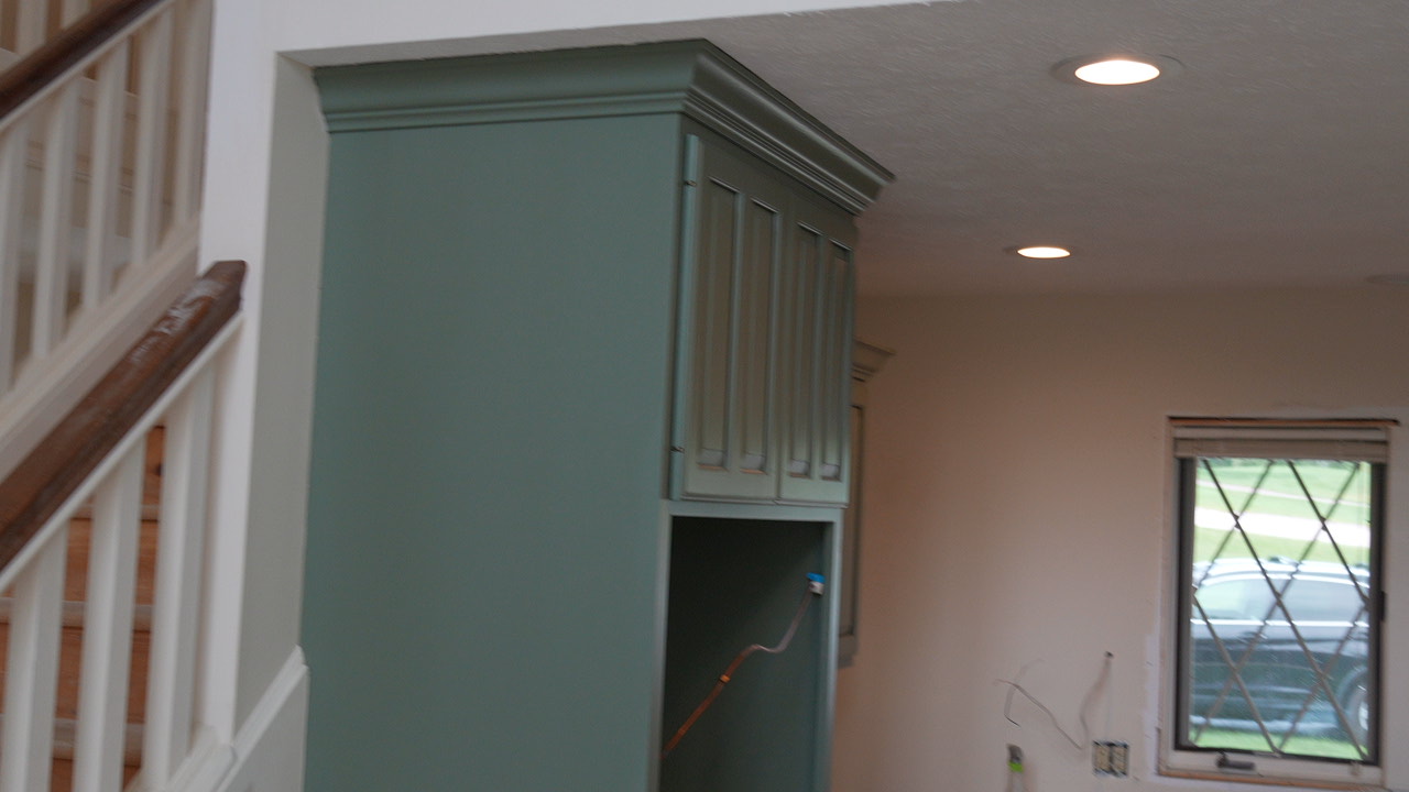 Muted green built-in cabinets