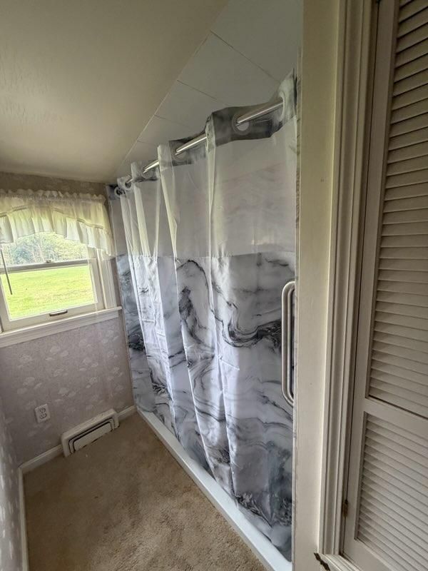 Bathroom shower enclosure beside a window